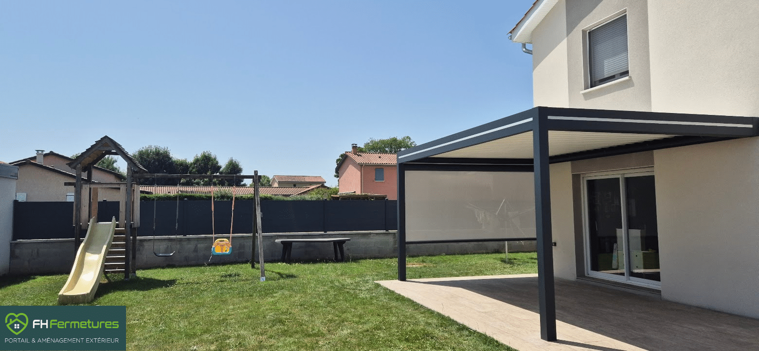 Pergola bioclimatique aluminium anthracite avec store latéral installée sur terrasse bois à Quincieux (69) par FH Fermetures